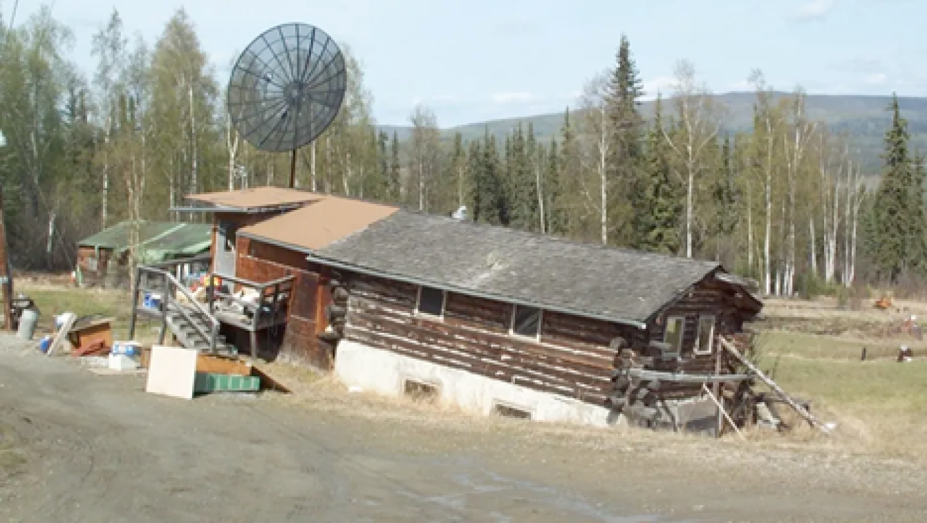 A private house north of Fairbanks is unevenly sinking into thawing ice-rich permafrost.