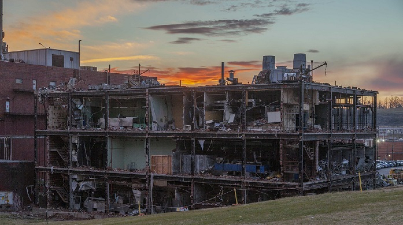 Workers clear the brick exterior of the three-story 65,000-square-foot Building 9210 at the Y-12 National Security Complex prior to demolition.