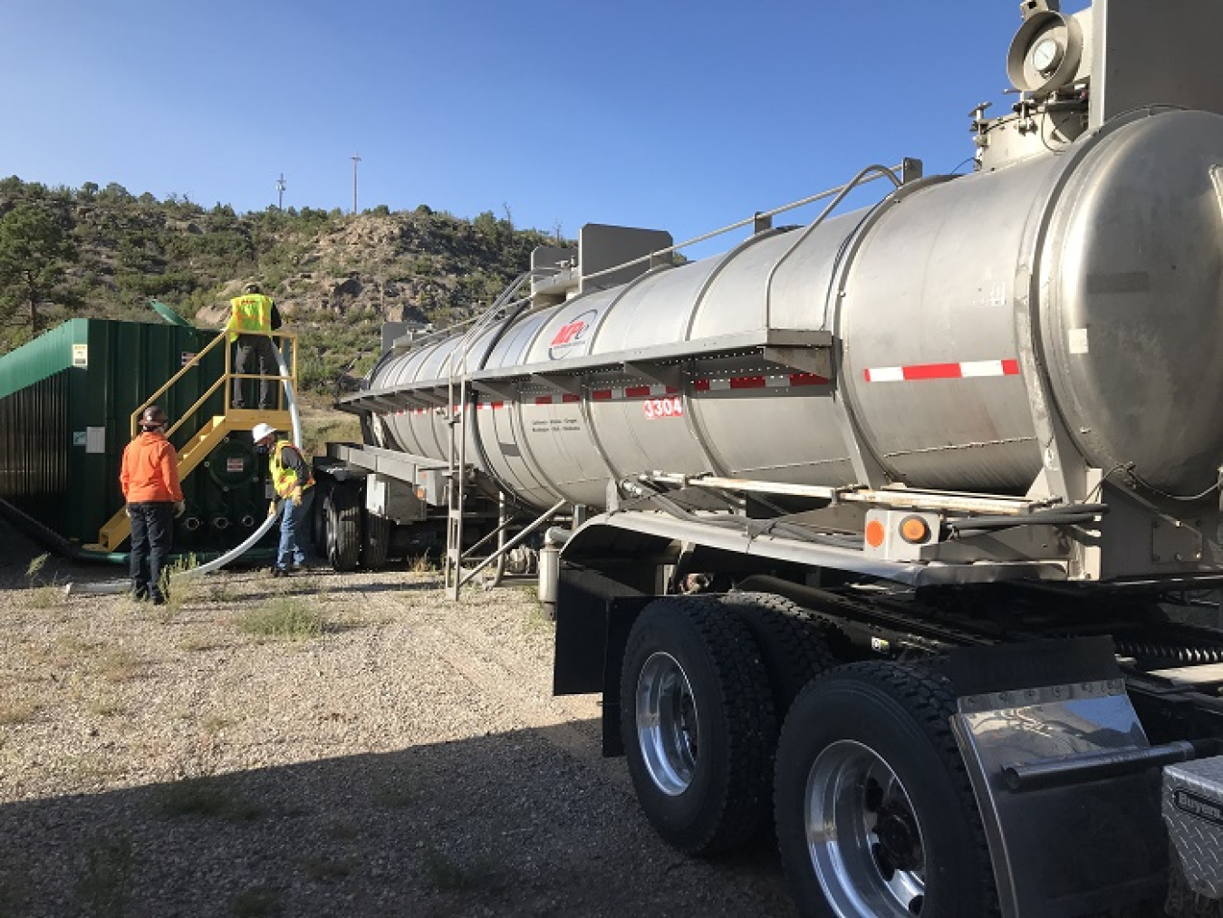 EM crews at Los Alamos National Laboratory empty purged well water into a truck for offsite disposal.