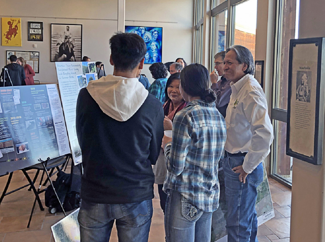 Bill Frazier (LM) and Mary Picel (Argonne National Laboratory) discuss the Riverton, Wyoming, site with students at a Northern Arapaho event.