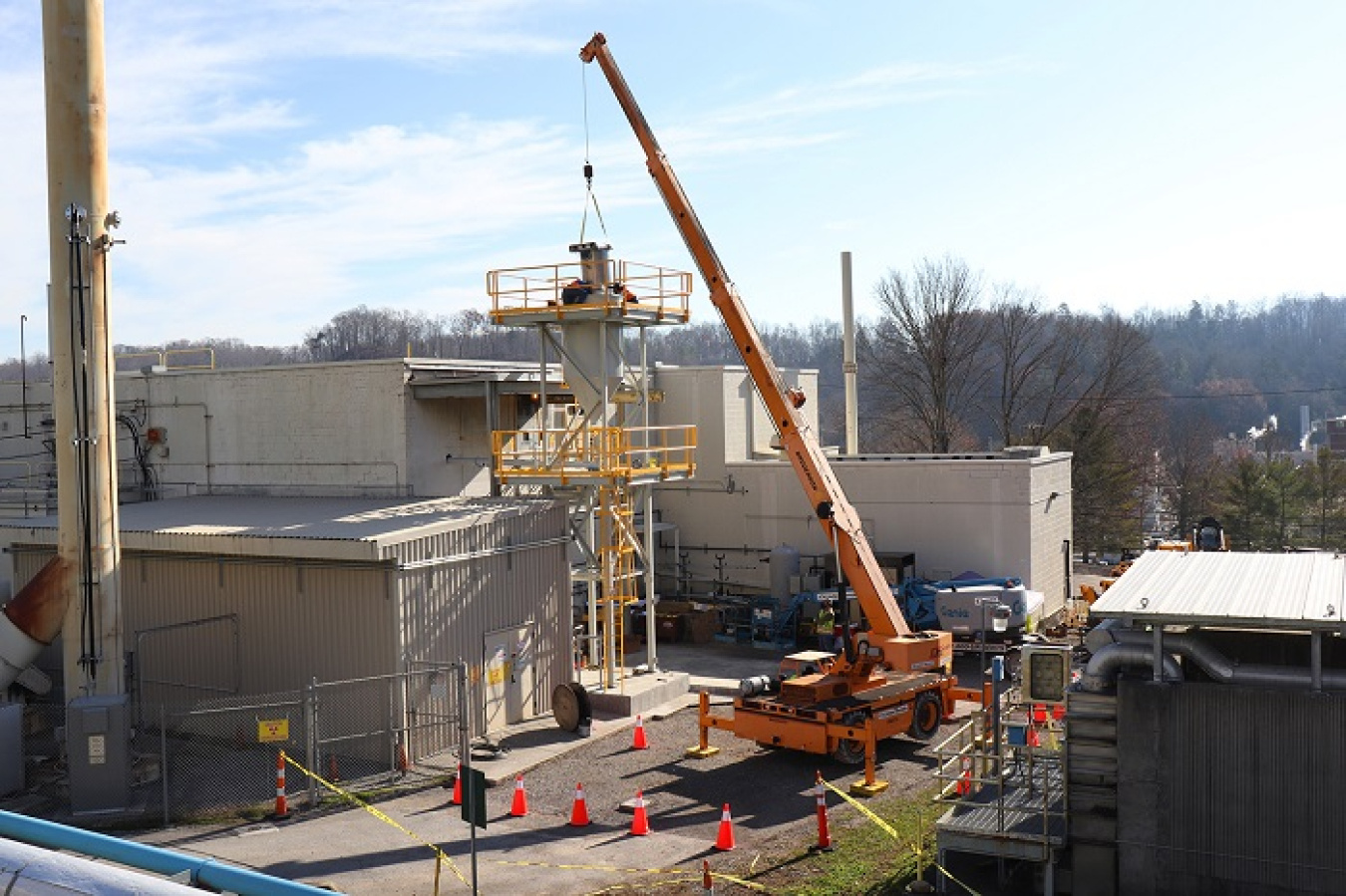 Crews install an 11,000-pound, 35-foot-tall silo that can hold 10,000 pounds of dry cement. Cement from the silo will be transferred to tanks containing the downblended uranium-233 to solidify the material and make it safe for transportation and disposal.