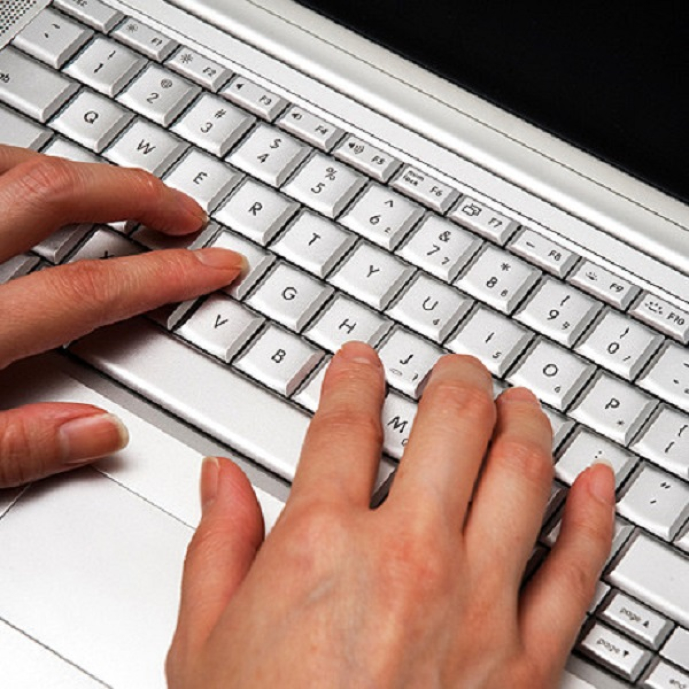 Hands on computer keyboard.