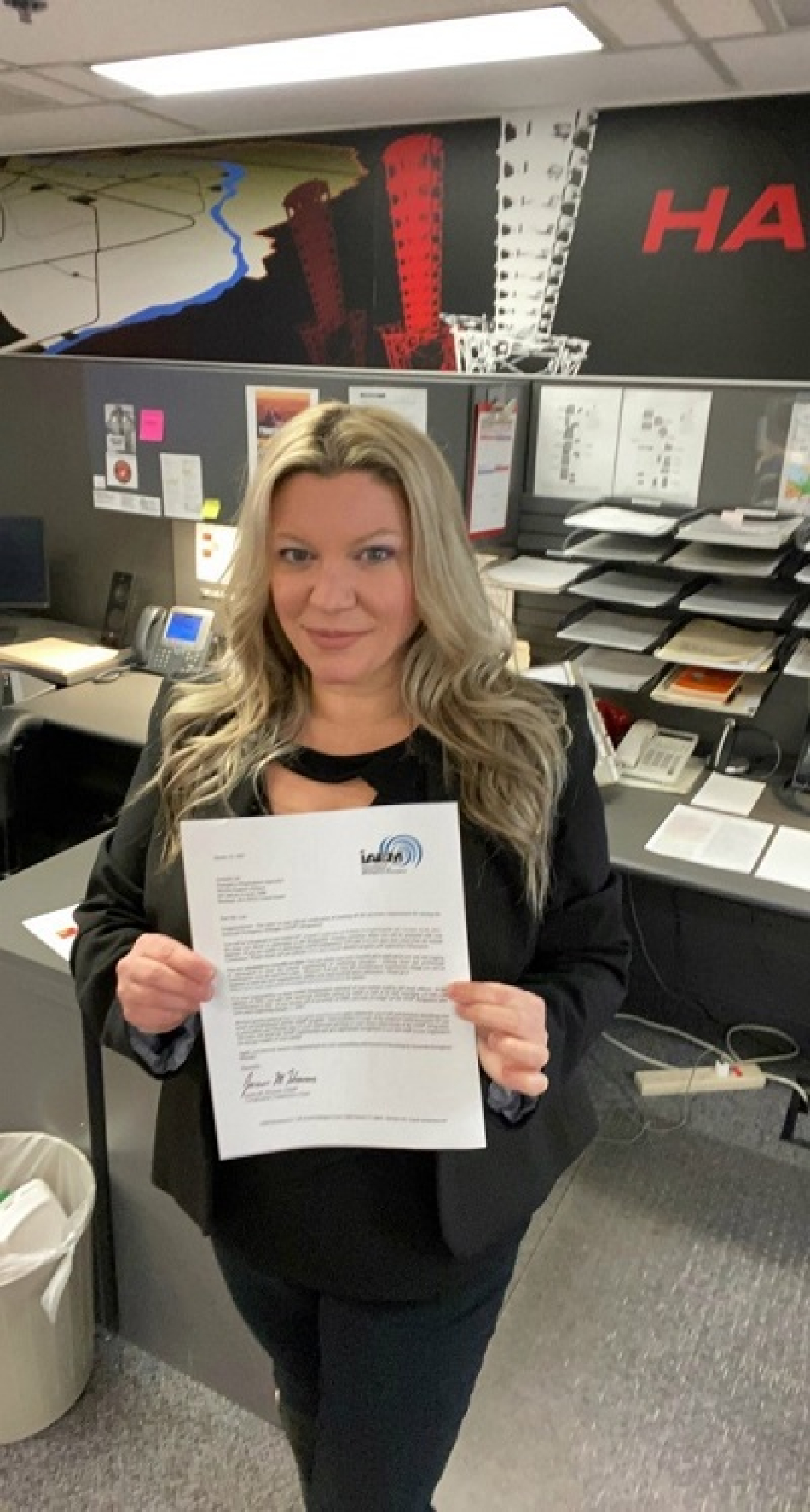 Emergency preparedness specialist Amanda Lee displays her certification notice inside the Hanford Emergency Operations Center.