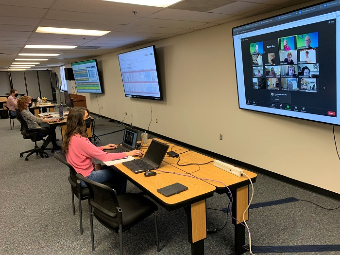 Savannah River Nuclear Solutions employees, from left, Tim Arnold, Kim Mitchell, and Taylor Rice work in the control center for the DOE Savannah River Regional Science Bowl competition, remotely coordinating the day-long event on Feb. 20.