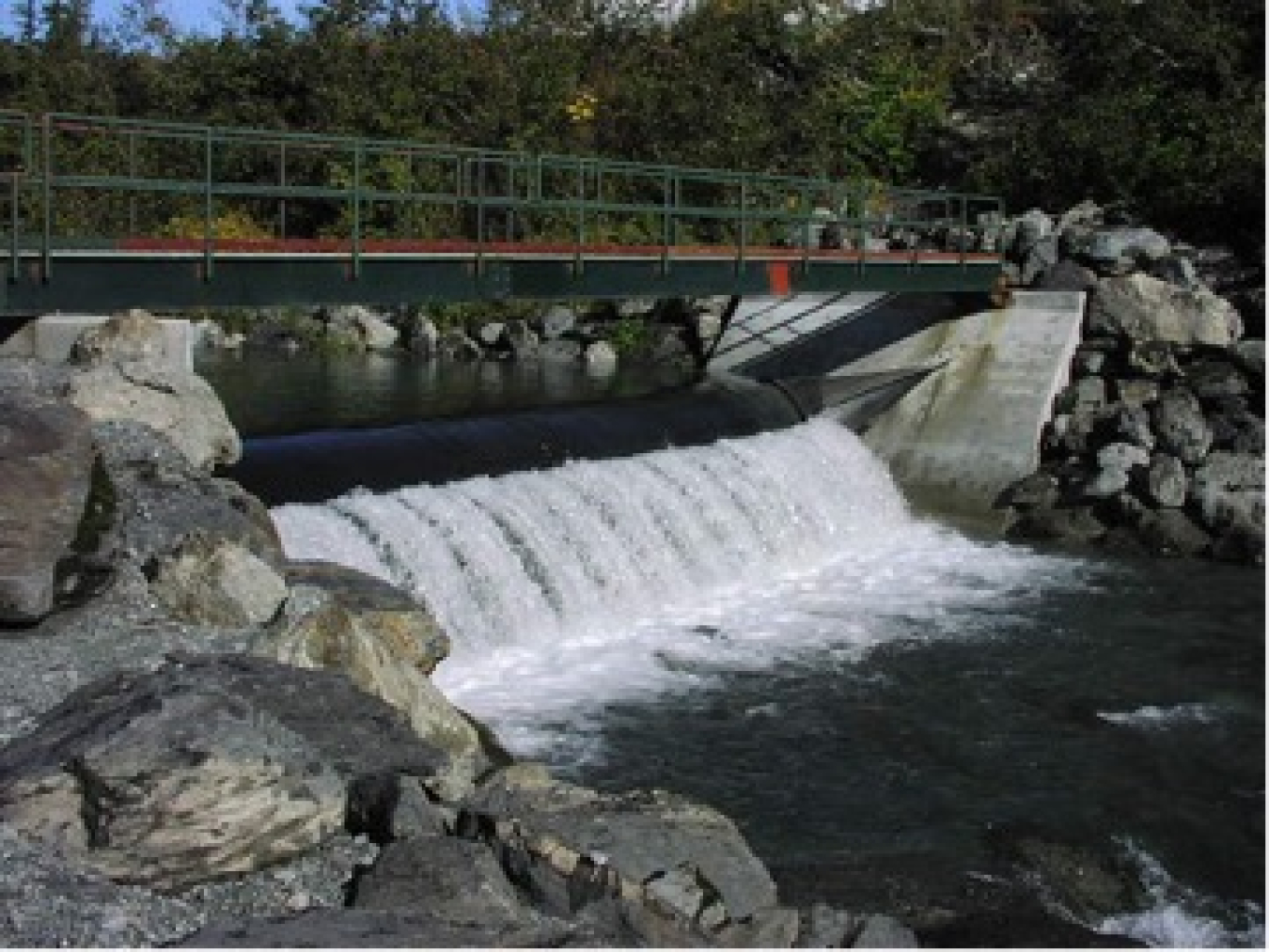 An inflatable bladder is used to allow natural passage of excess water, river debris and gravels at the Power Creek run-of-the-river hydroelectric facility. 