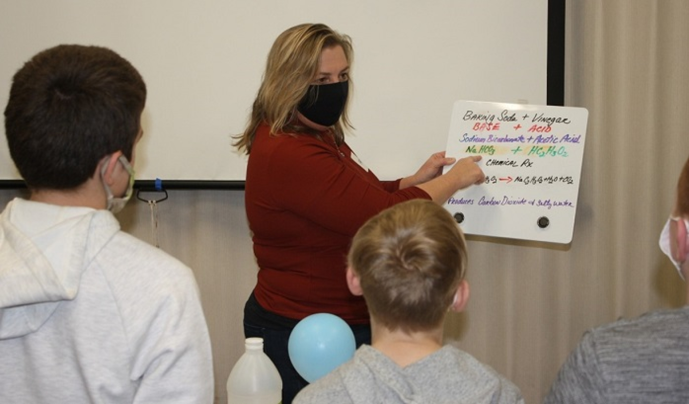 Pam Baird of Fluor-BWXT Portsmouth explains a science experiment to fifth-grade students at Western Elementary School.