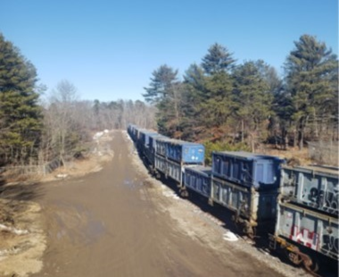 Sixty-five waste containers loaded onto railcars await shipment away from Brookhaven National Laboratory. It is the first of two expected shipments of debris from the exhaust stack demolition.