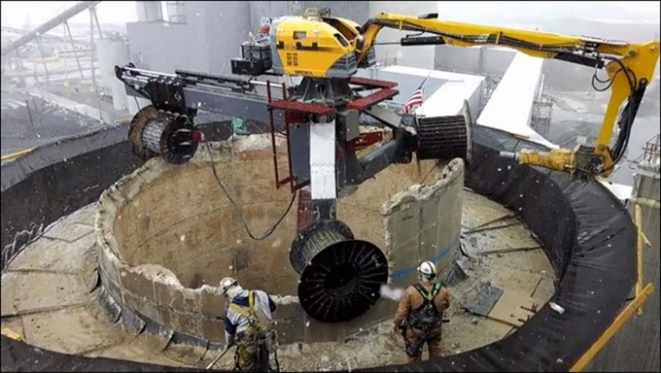 EM Crews use the MANTIS system to safely demolish the High Flux Beam Reactor exhaust stack, a prominent part of the Brookhaven National Laboratory. The MANTIS is a remotely operated demolition system for concrete chimneys.