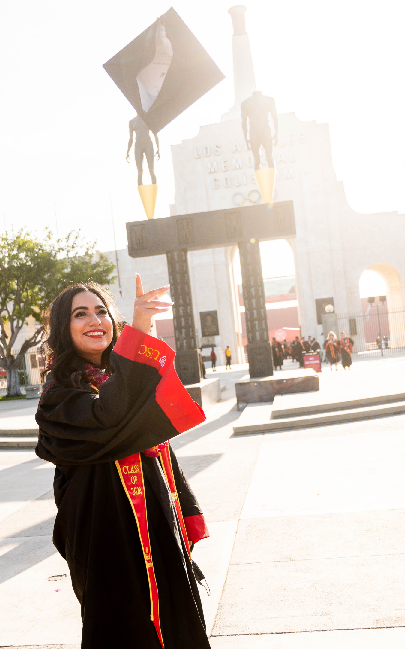 Gaby Ibarra tosses a graduation cap into the air.