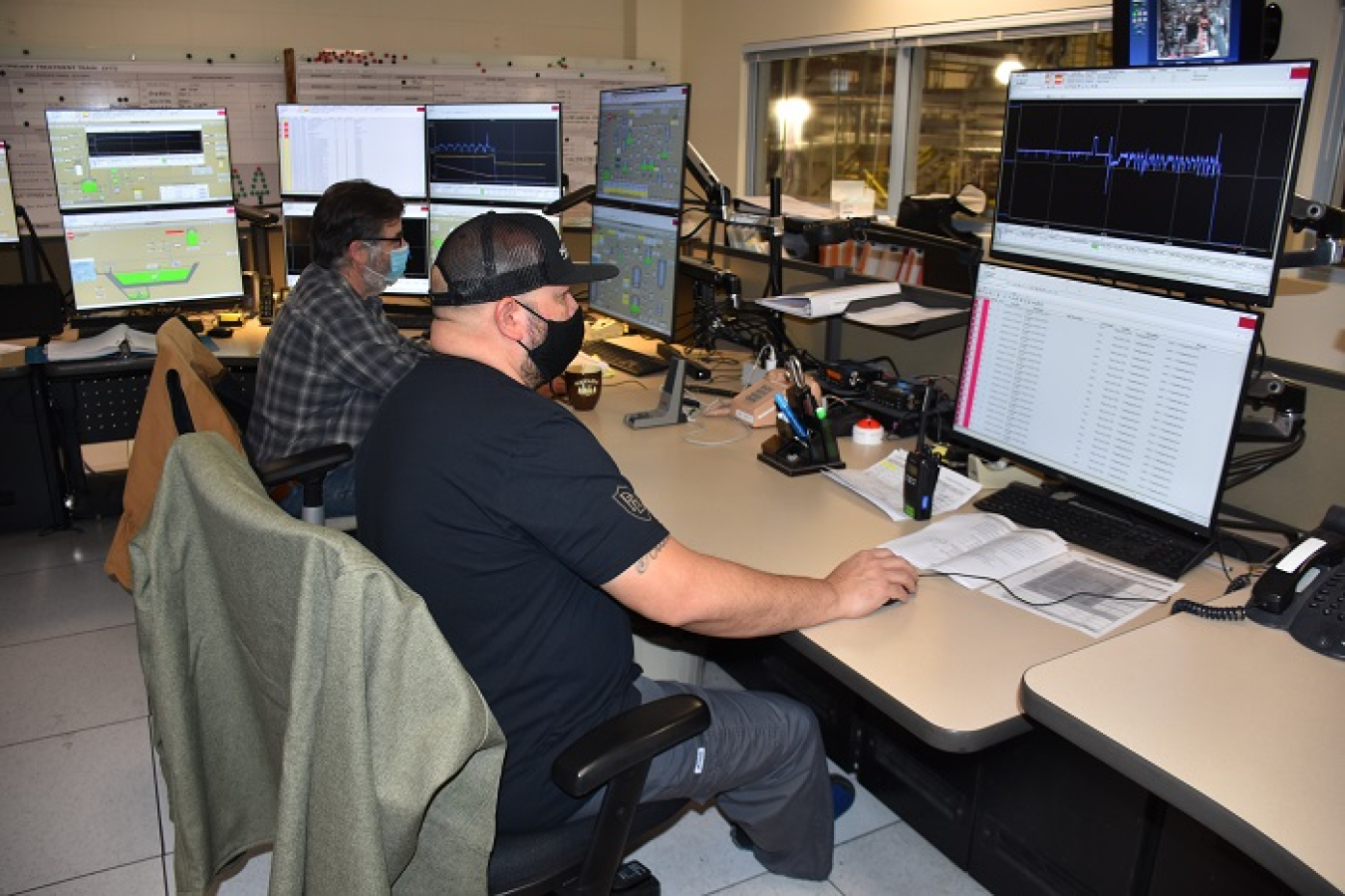 Washington River Protection Solutions nuclear chemical operators George Gilmour, back, and Clint Davidson, front, monitor readings in the Effluent Treatment Facility control room at the Hanford Site. After extensive equipment upgrades, the facility is conducting its fiscal 2022 wastewater processing campaign.