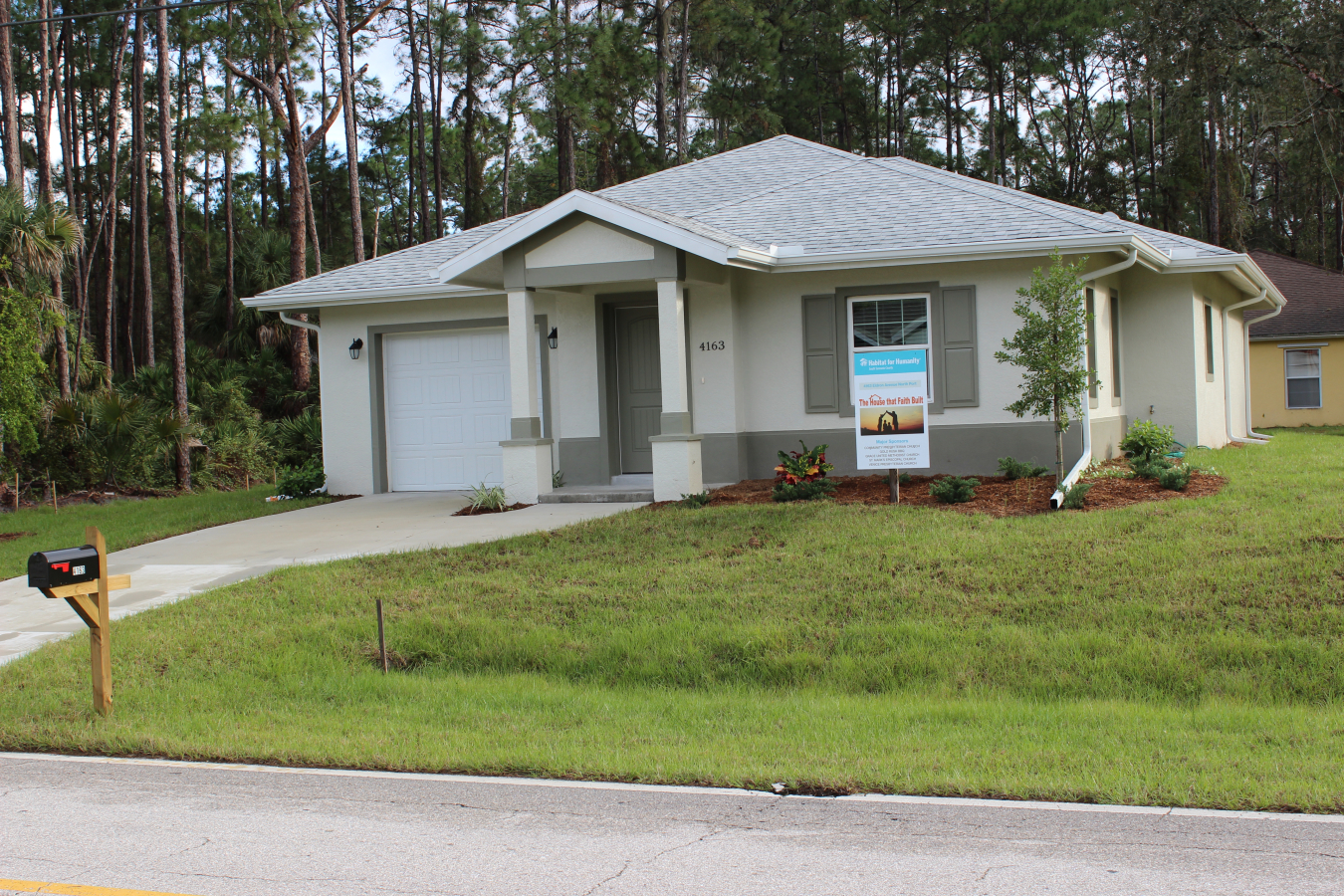 House with Habitat for Humanity sign in front.