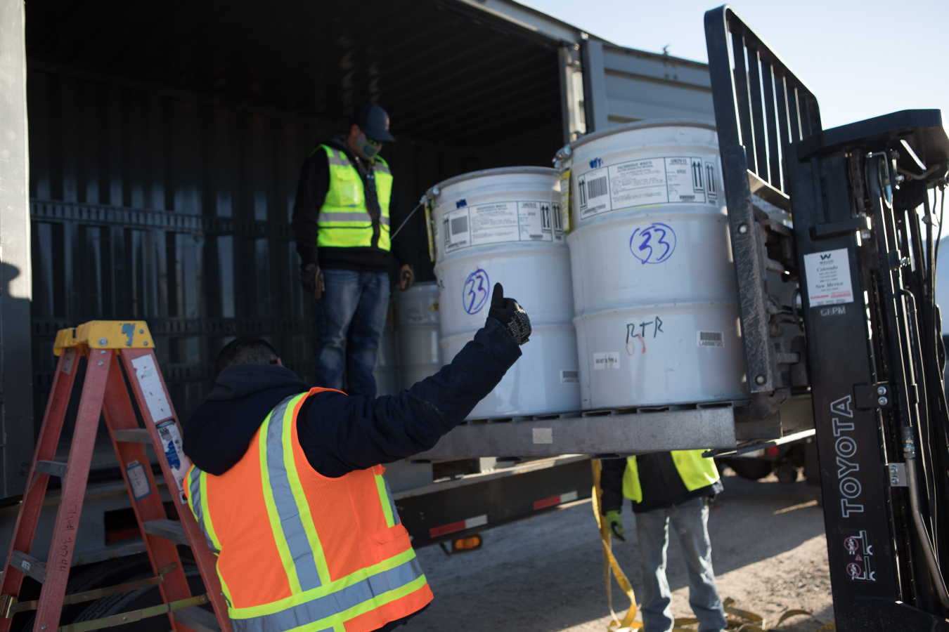 Crews with Newport News Nuclear BWXT-Los Alamos (N3B) load drums with transuranic (TRU) waste for shipment to the Waste Isolation Pilot Plant (WIPP). N3B certified and completed more than 30 legacy TRU waste shipments to WIPP — exceeding an EM 2021 priority.