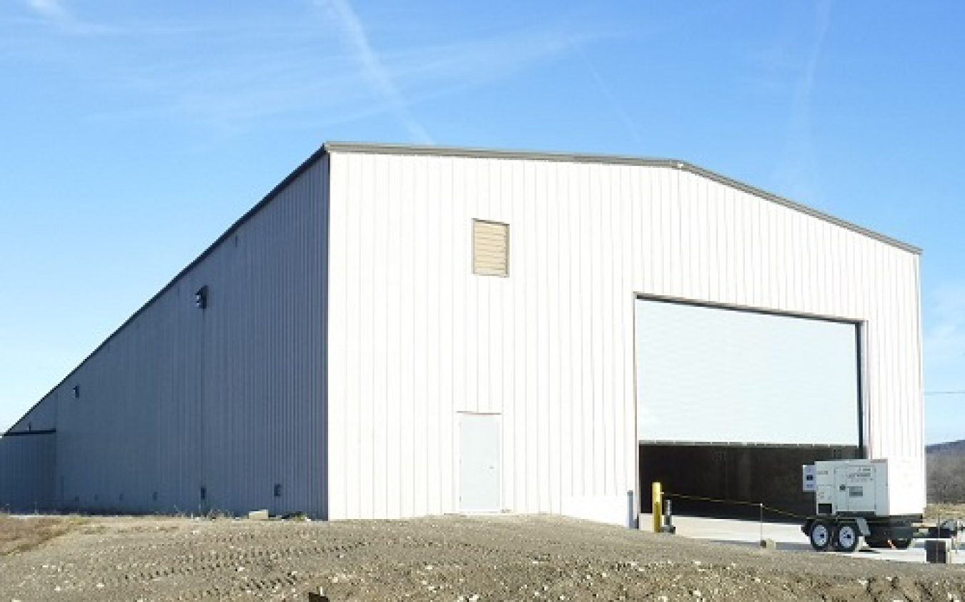 A new roll-up door is installed on a former storage facility at the West Valley Demonstration Project.