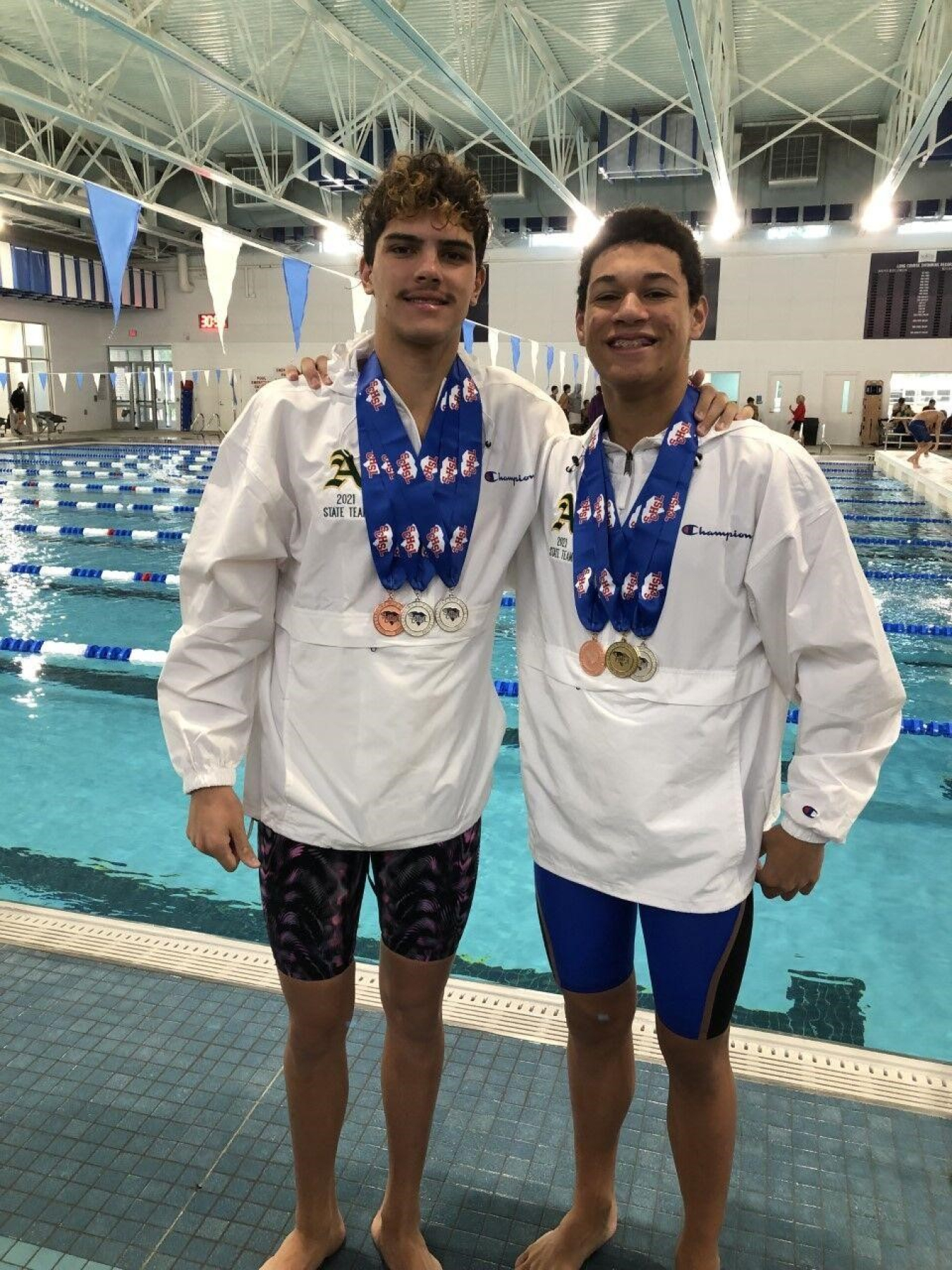 Jared Allison (right) displays his state championship medal