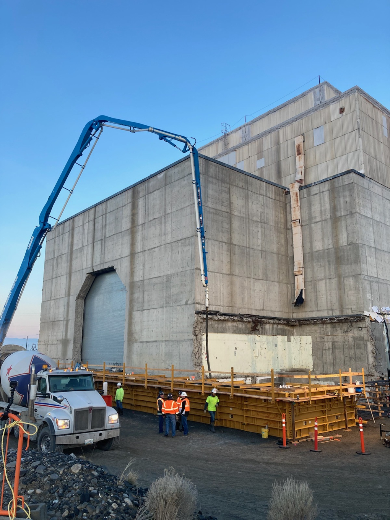 Workers with EM contractor Central Plateau Cleanup Company pour concrete for a 6-foot-thick foundation to support a massive steel structure over the former K East Reactor building. 