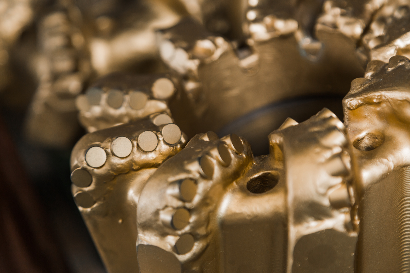 Closeup of gold colored drilling bits.