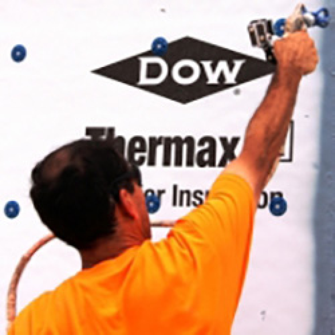 A man spraying a wall.