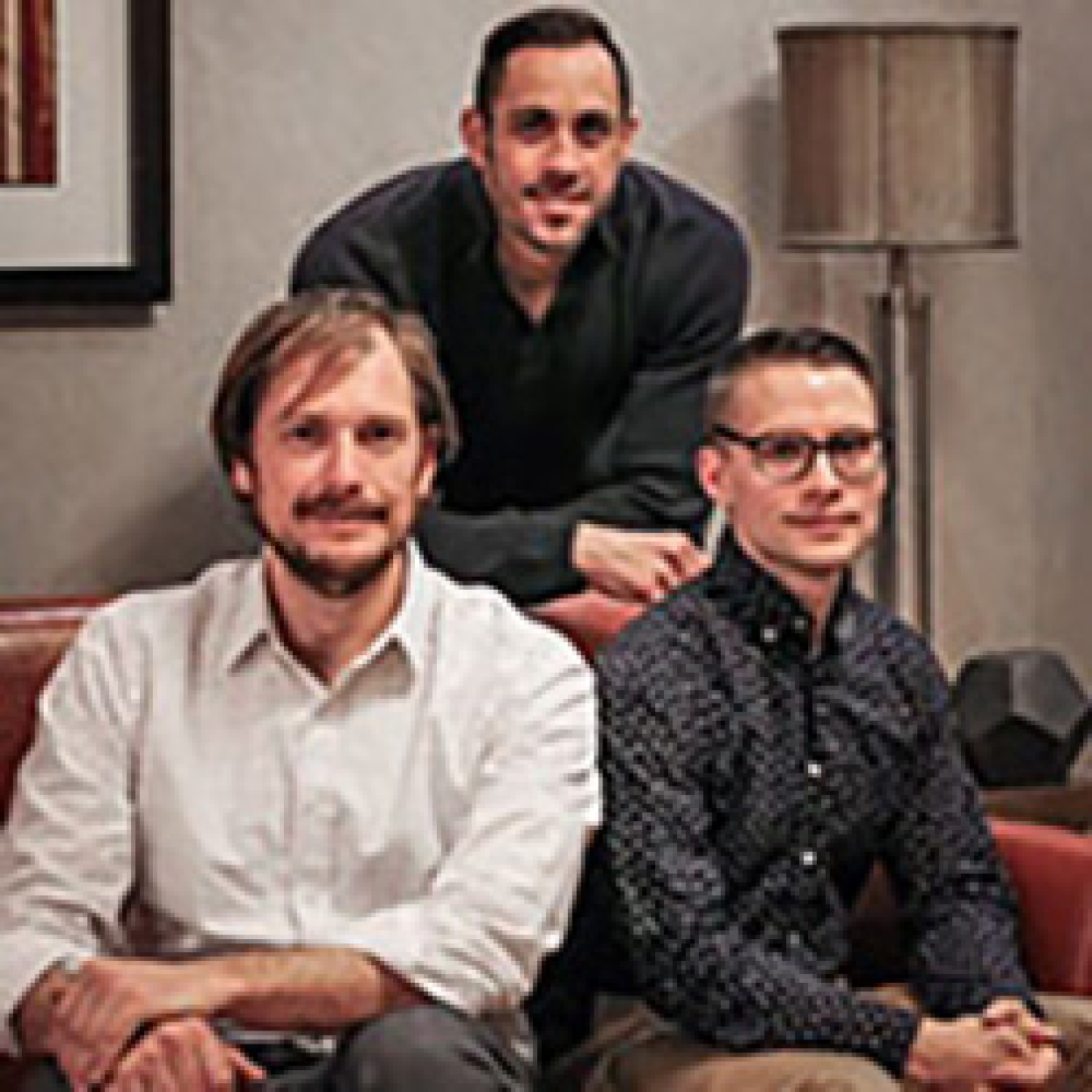 Three men smiling