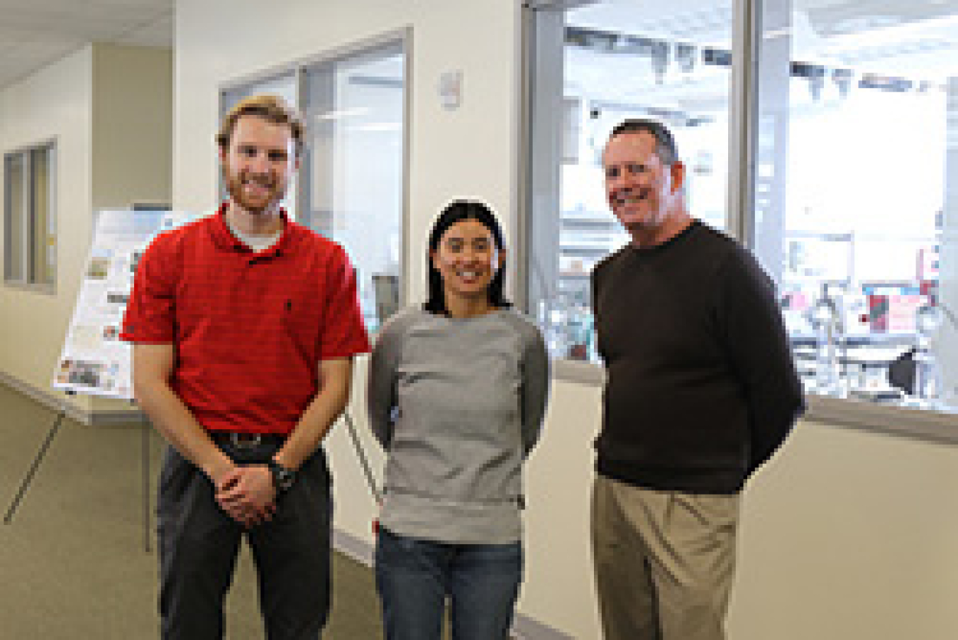 Three people smiling.