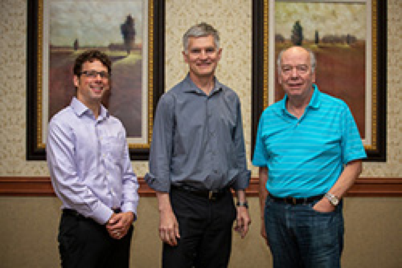 Three men smiling