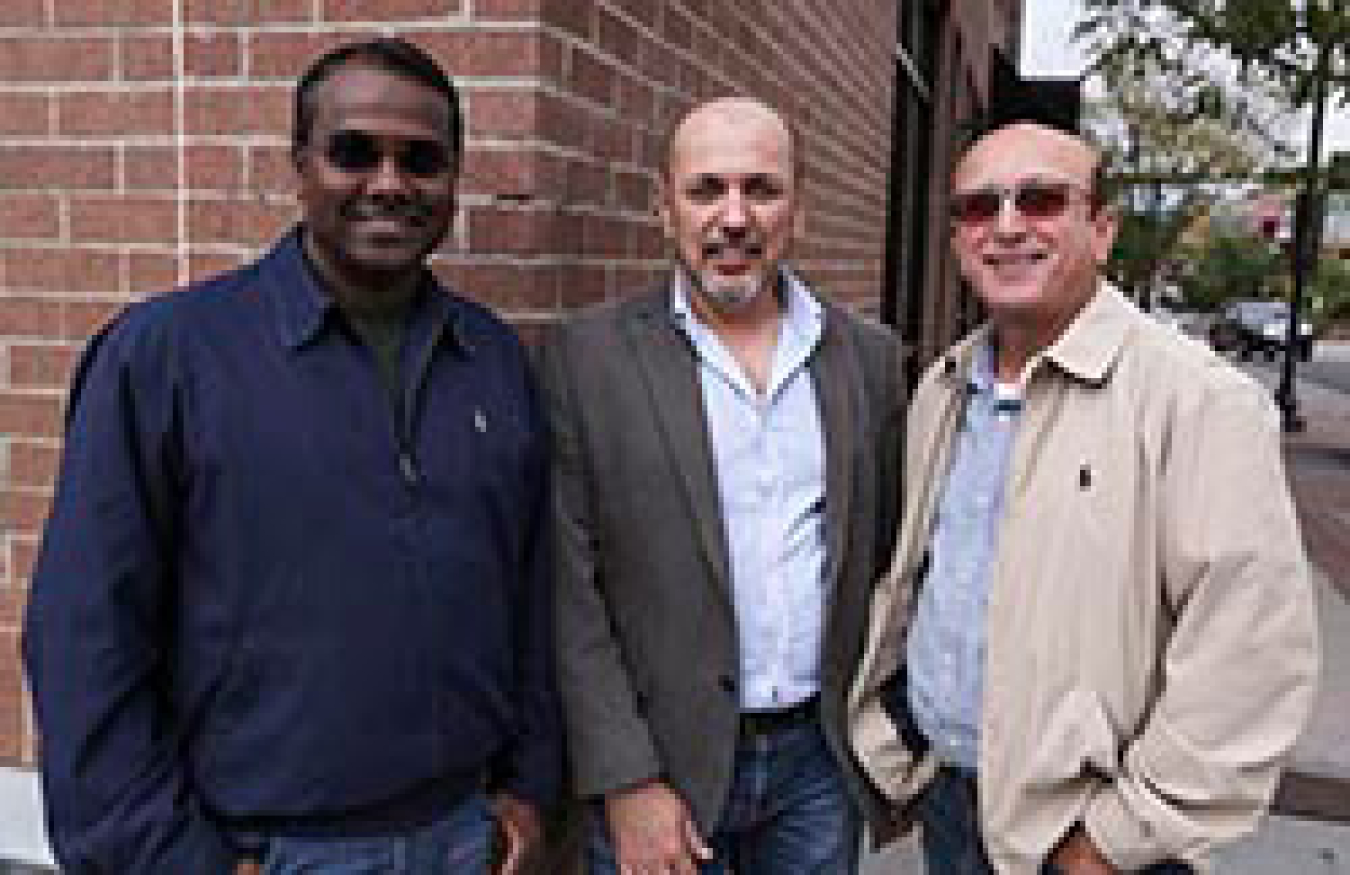 Three men smiling