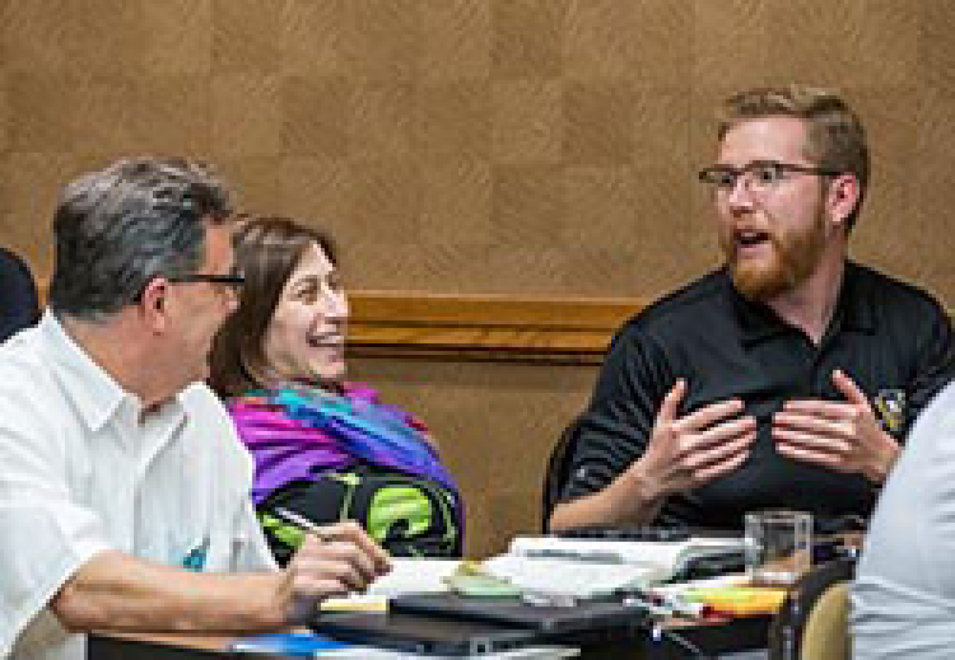 Two men and a woman talking.