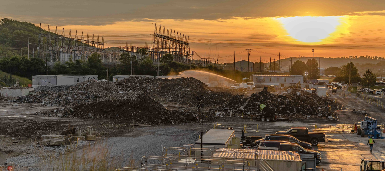 Workers clear away the final debris from Biology Complex demolition project. The effort removed 11 deteriorated structures and opens land for national security missions at Y-12.