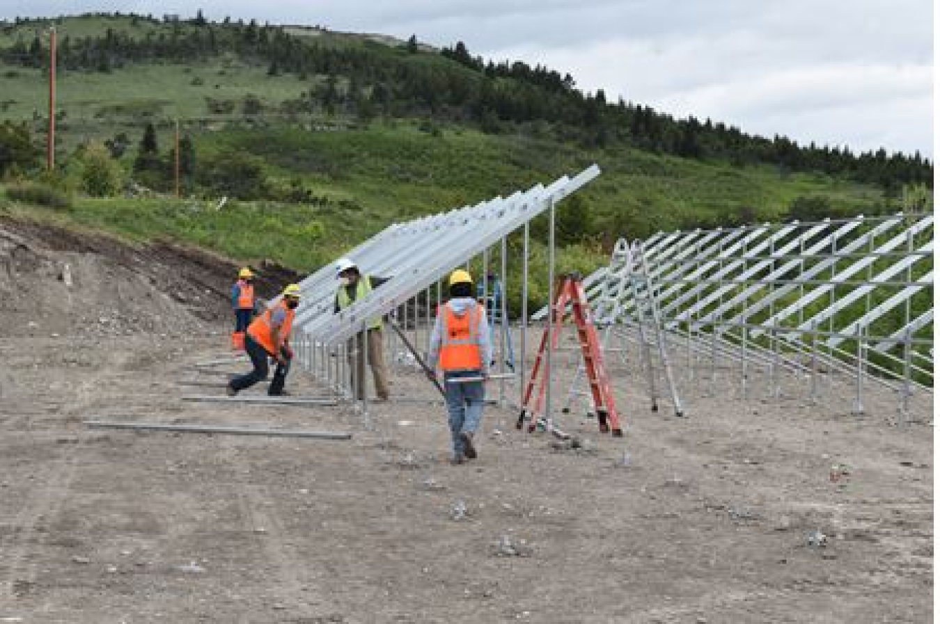 Trainees installing a community solar array.