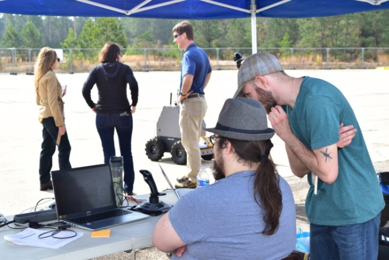 Wade Sheldon, system integrator of NuHorizon Technologies, seated, and Steven Hendry, NuHorizon principal investigator for the Integrated Ground-based Autonomous Agent for Radiological Tracking (iGART) project, review data during a demonstration of the iGART technology.