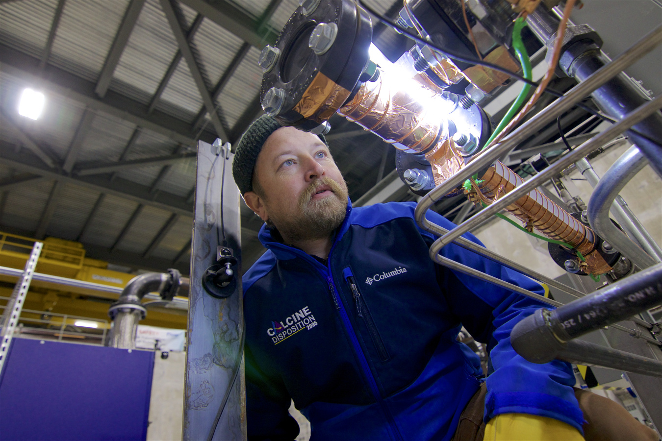 A mechanical engineer inspects calcine retrieval technology.