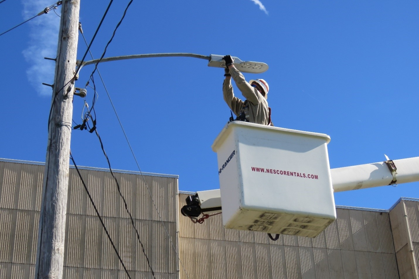 An electrical mechanic for Swift & Staley Inc., the infrastructure contractor for EM’s Paducah Site, finishes the electrical tie to a newly installed streetlight.