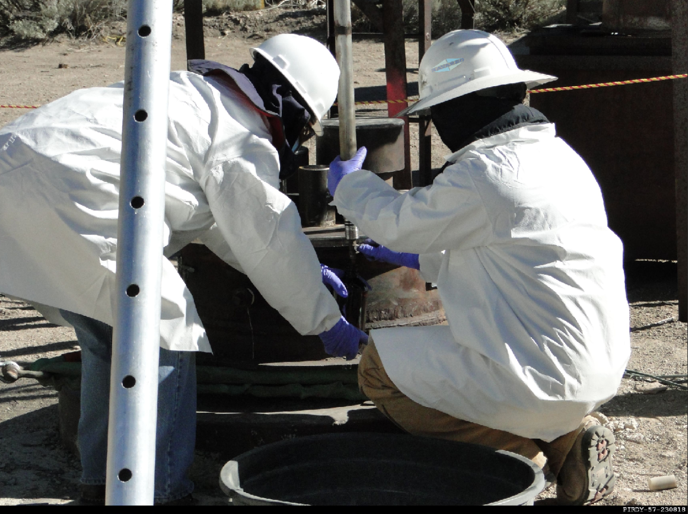 Technicians collect samples from a groundwater well at the NNSS.