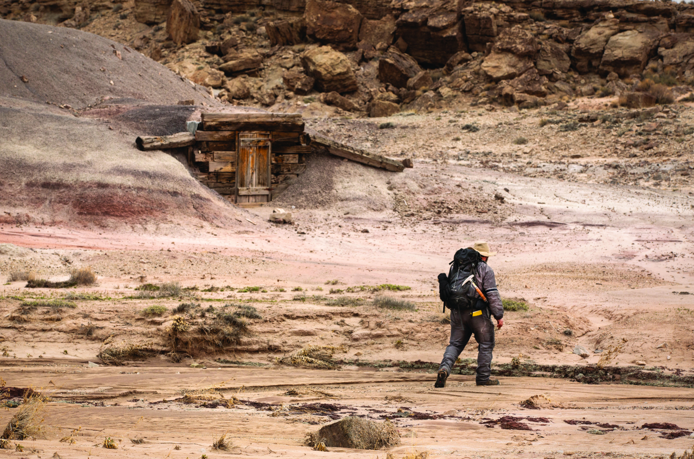 A DRUM team member approaching an abandoned uranium mine to survey its features.