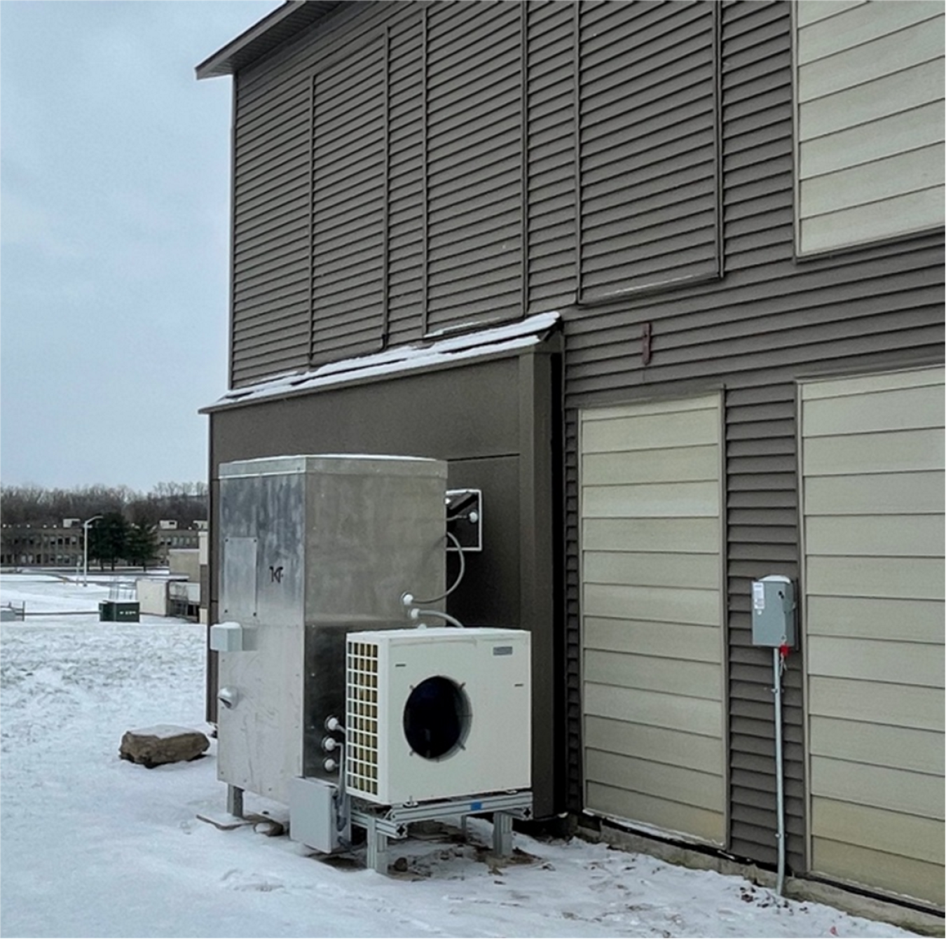 A multifamily building with the HVAC equipment showing on one side.