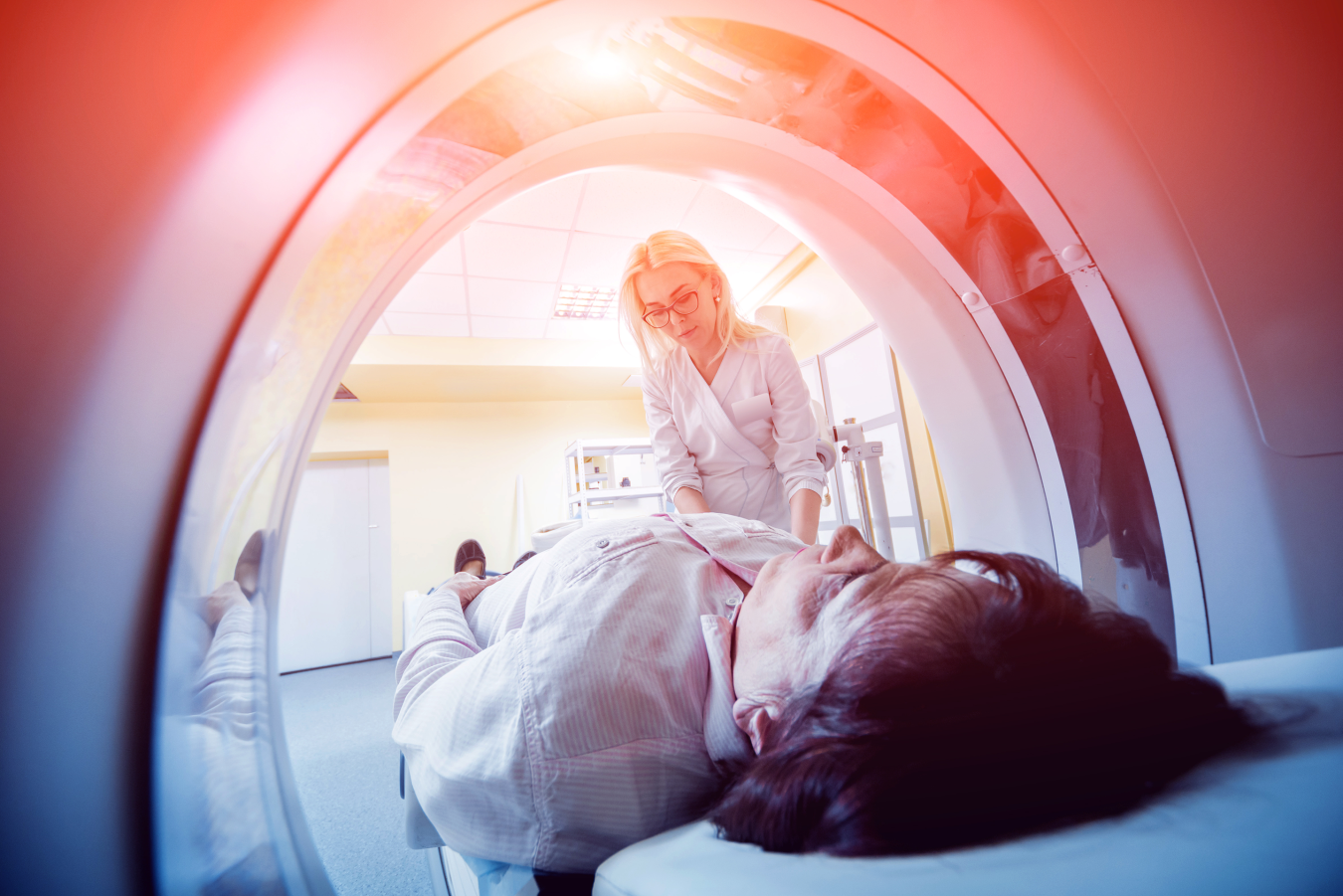 A radiology technologist  preparing to perform a CT scan on patient