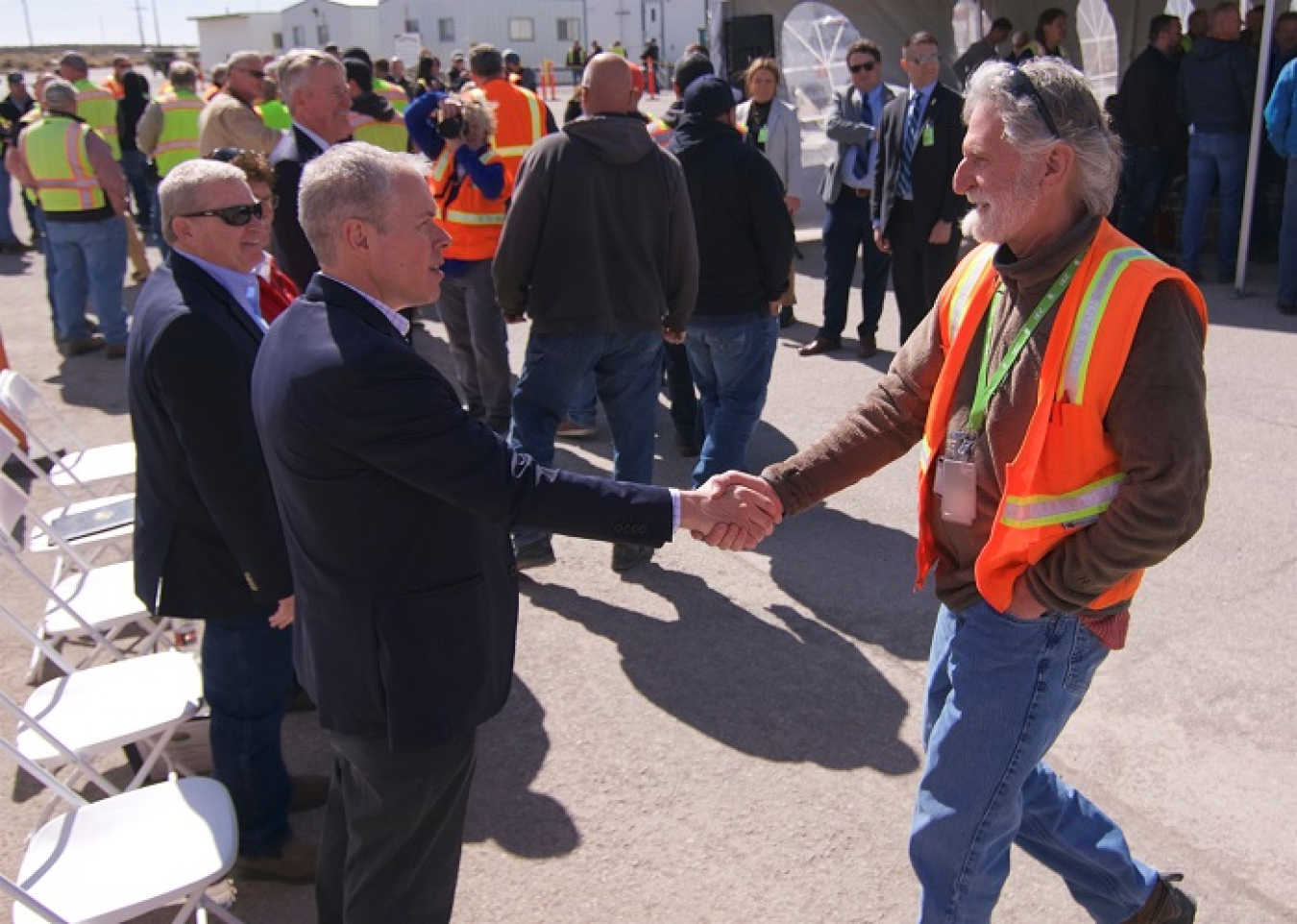 EM Senior Advisor William “Ike” White greets Idaho Environmental Coalition Fire Protection Engineer Thomas Bechtold last week during a celebration to commemorate the completion of targeted buried waste exhumation from the Subsurface Disposal Area