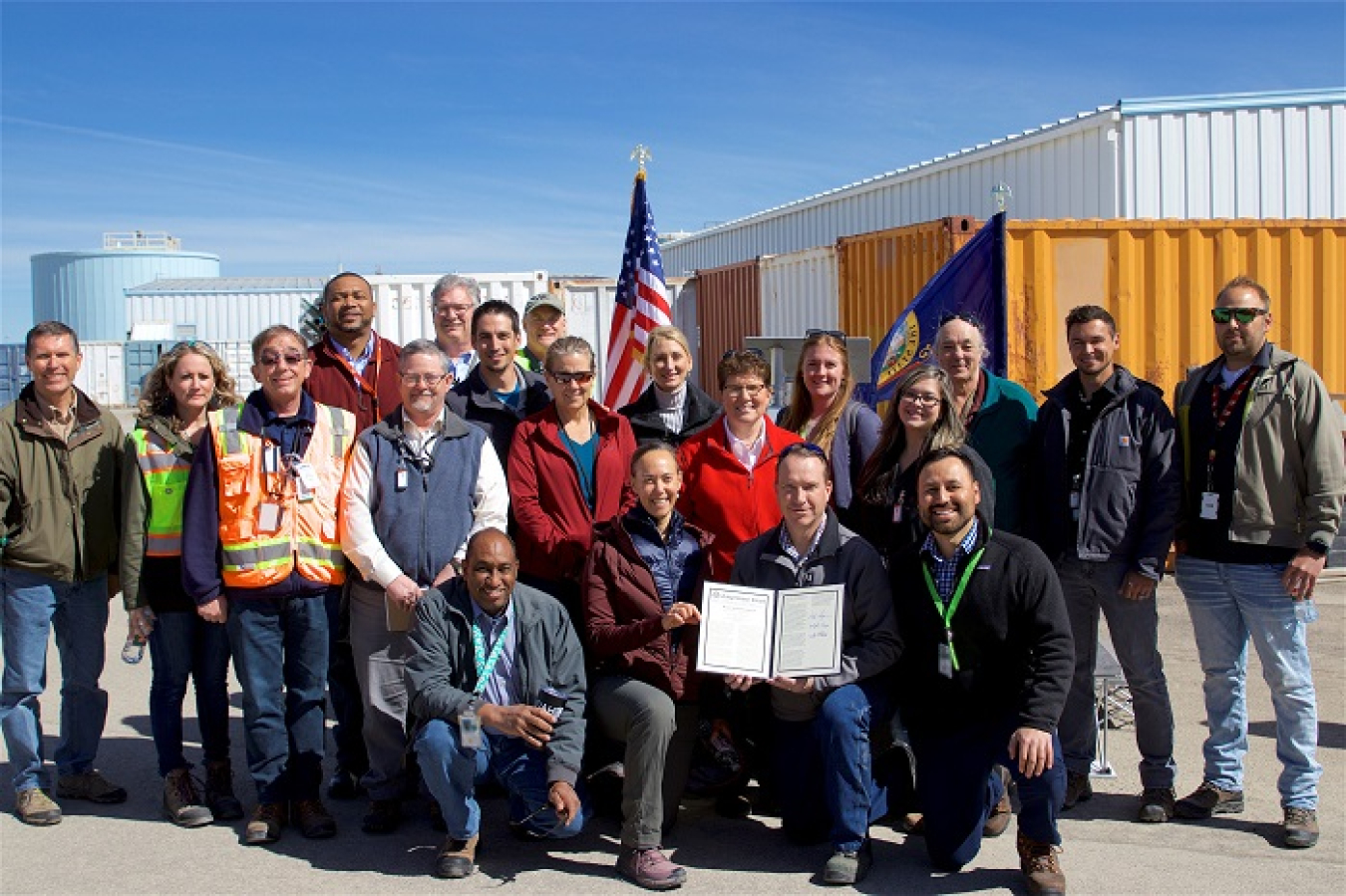 DOE employees display an official entry of the Congressional Record thanking Accelerated Retrieval Project employees for completing a targeted buried waste retrieval project early and protecting Idaho’s Snake River Plain Aquifer.