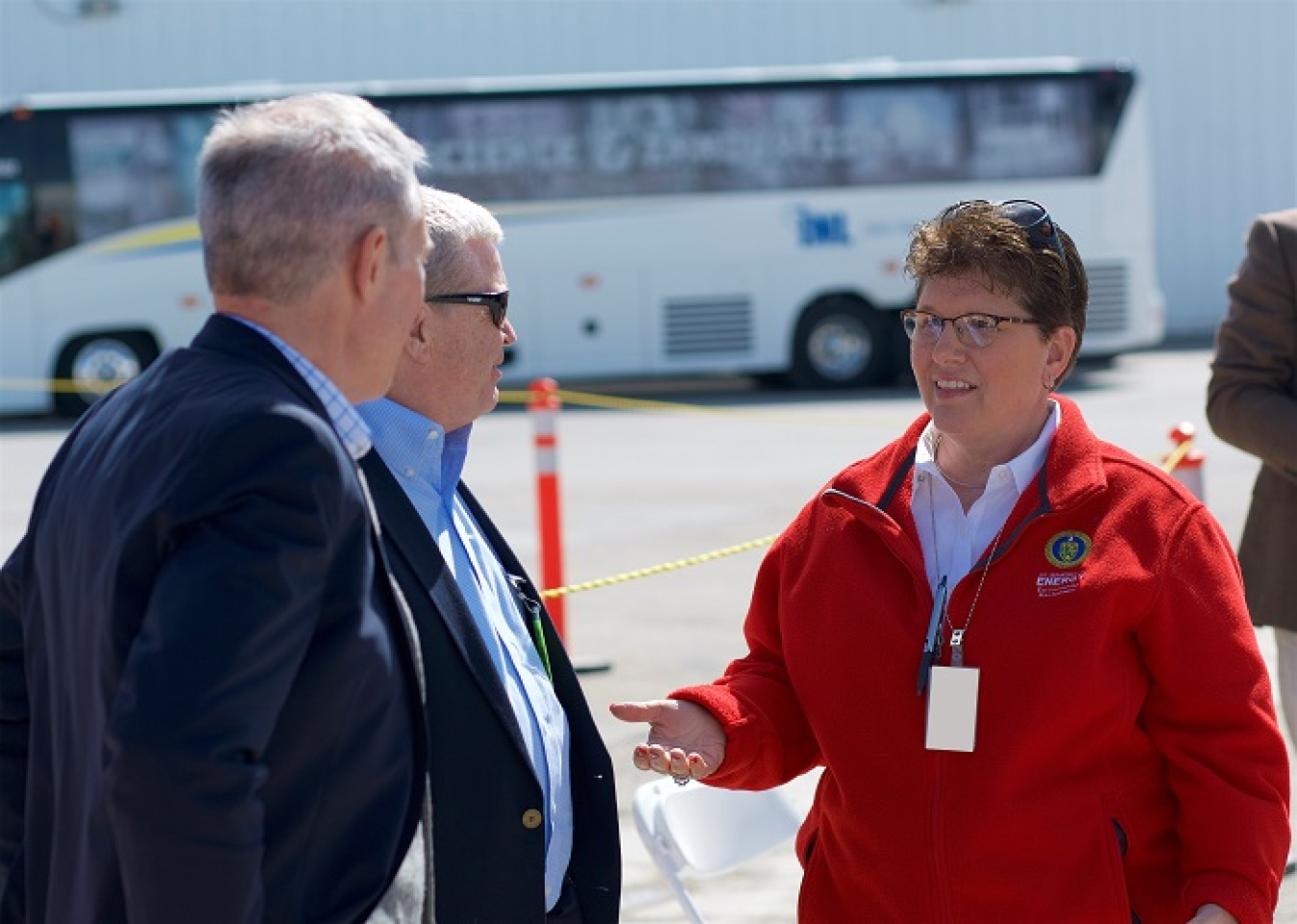 EM Idaho Cleanup Project Manager Connie Flohr speaks with EM Senior Advisor William “Ike” White, left, and Idaho Attorney General Lawrence Wasden at a targeted buried waste exhumation completion celebration last week at the DOE Idaho National Laboratory Site.