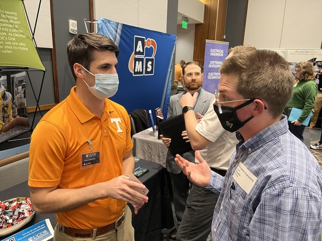 UCOR employee Cannon Buechley, left, a graduate of the University of Tennessee, speaks with student Houston Phillips about careers supporting the cleanup mission at Oak Ridge during the University of Tennessee’s Spring 2022 Engineering Expo. UCOR conducted 42 interviews with students after receiving resumes at the event.