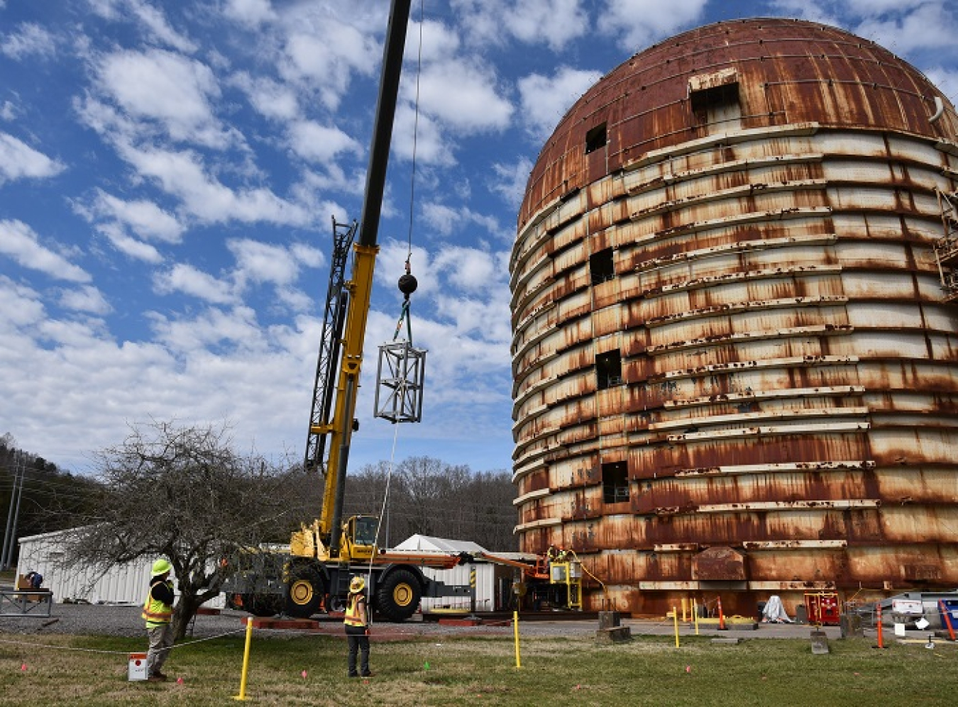 Workers install platforms to support deactivation crews and cleanout activities in the eight-story Experimental Gas Cooled Reactor at Oak Ridge National Laboratory (ORNL).