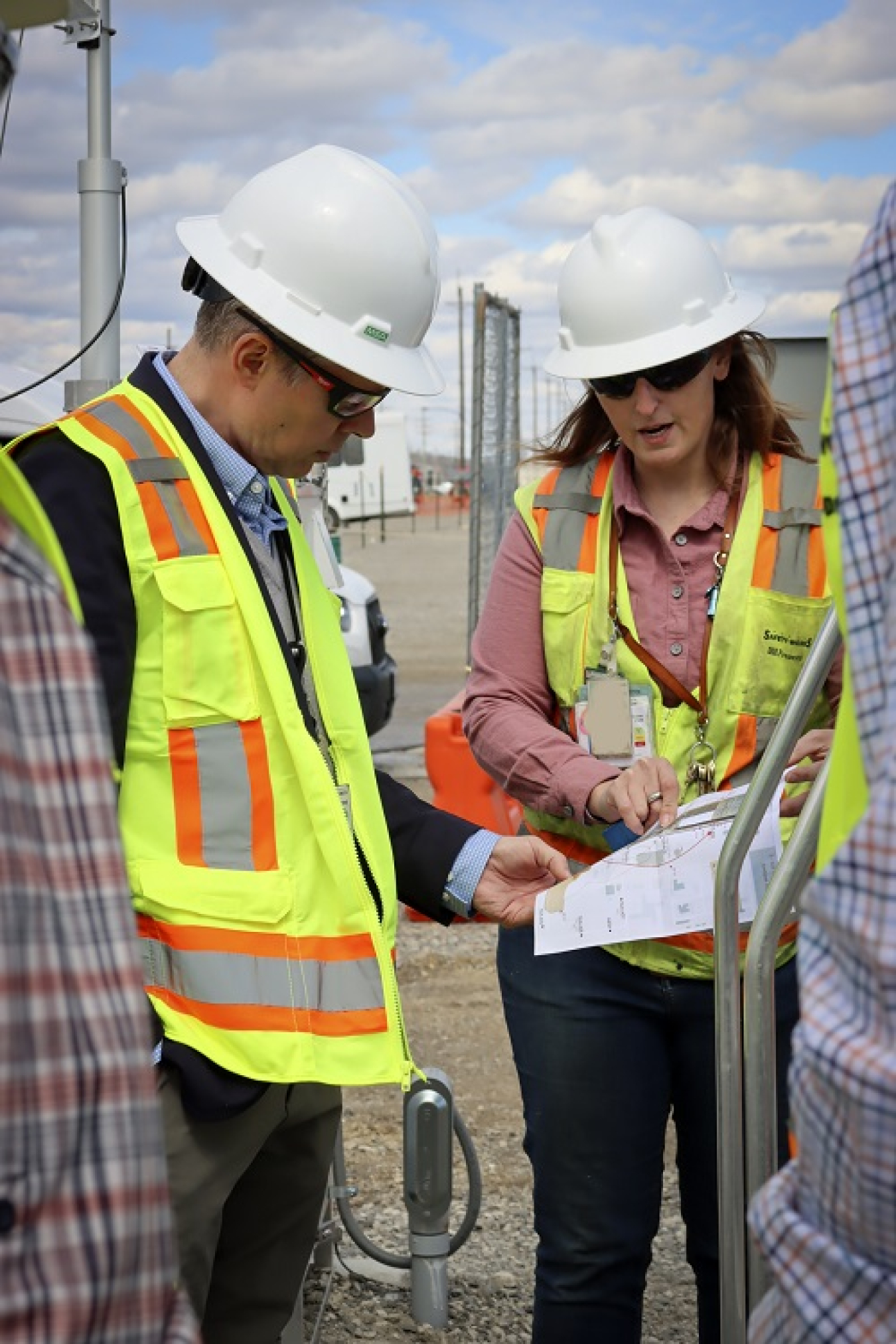 Fluor-BWXT Portsmouth Environmental Science Supervisor Danielle Stumbo explains the Portsmouth Site’s air monitoring network to EM Senior Advisor William “Ike” White.