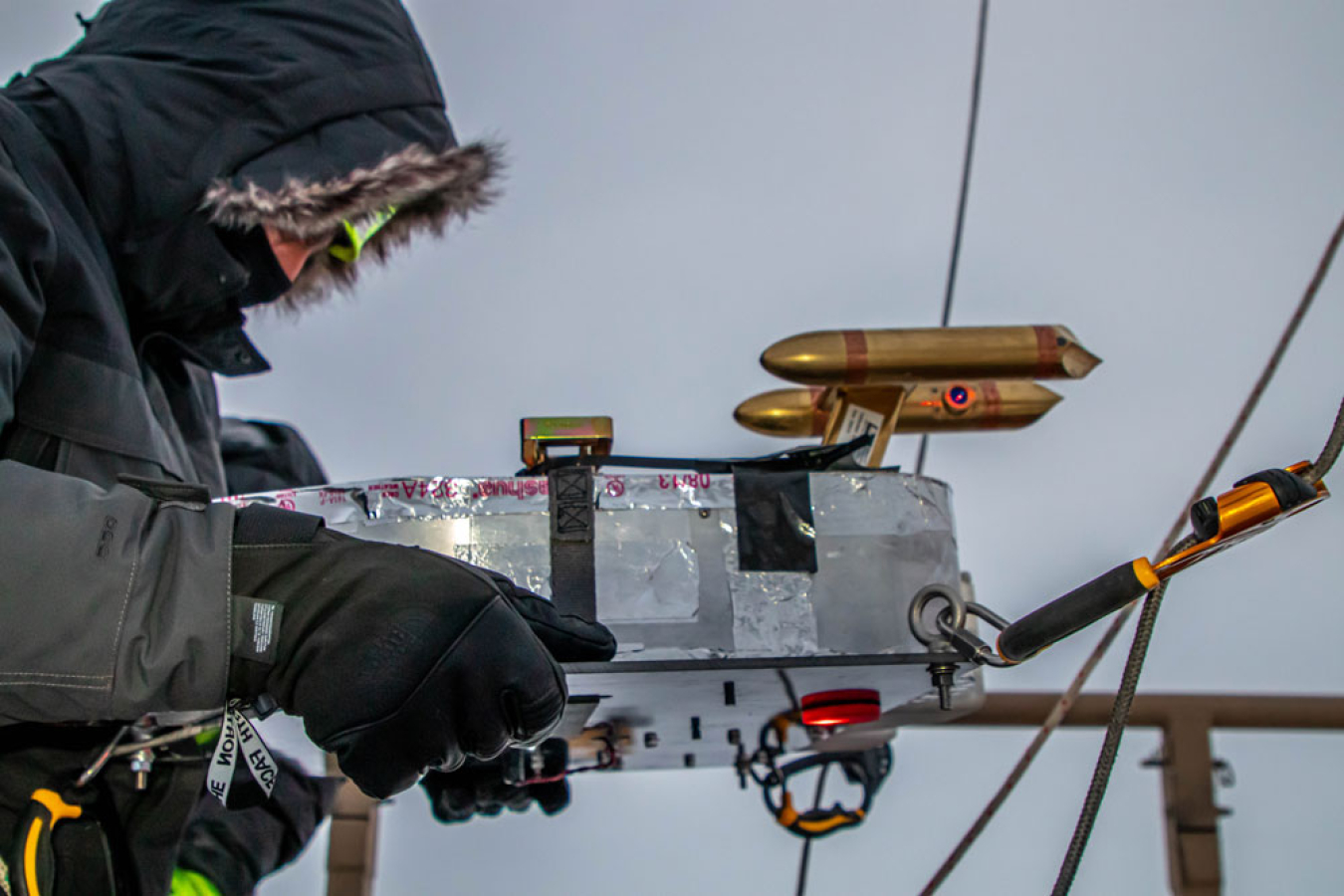 A researcher prepares to launch a balloon for atmosphere studies on the North Slope.