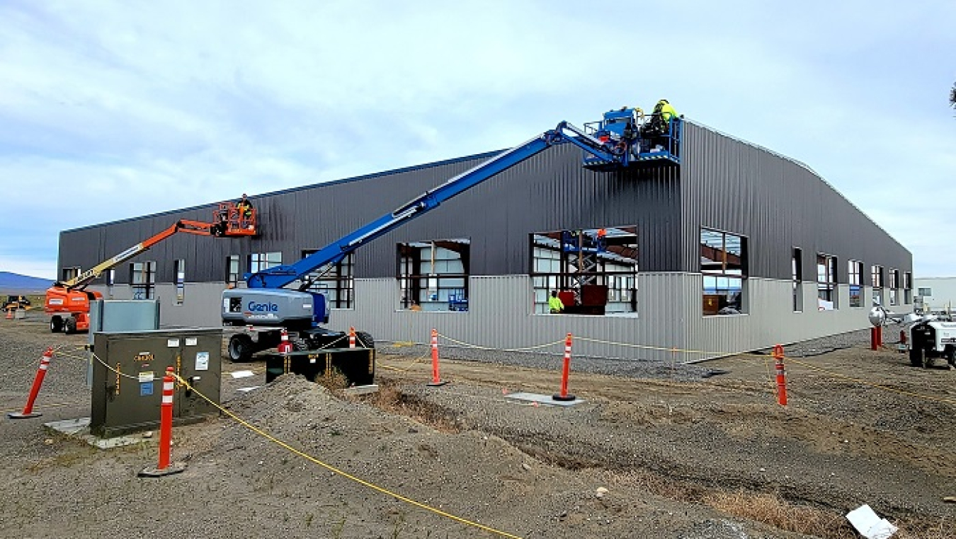 Workers with subcontractor Fowler General Construction finish installing metal sheeting at a new office building in the Hanford Site’s 200 West Area.