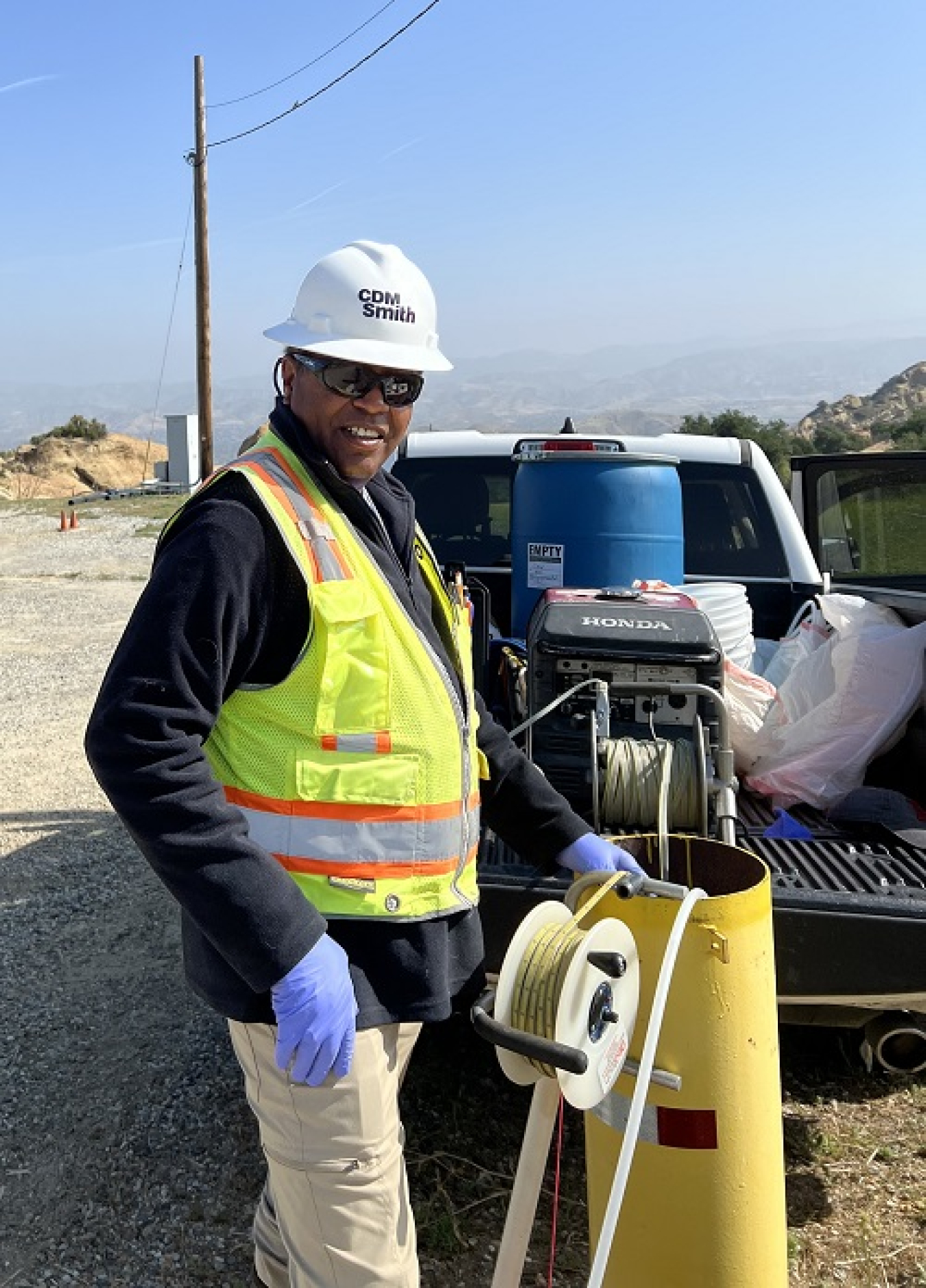 DOE-contracted field technician Preston Butler measures the depth to groundwater at an extraction well at the Energy Technology Engineering Center site.