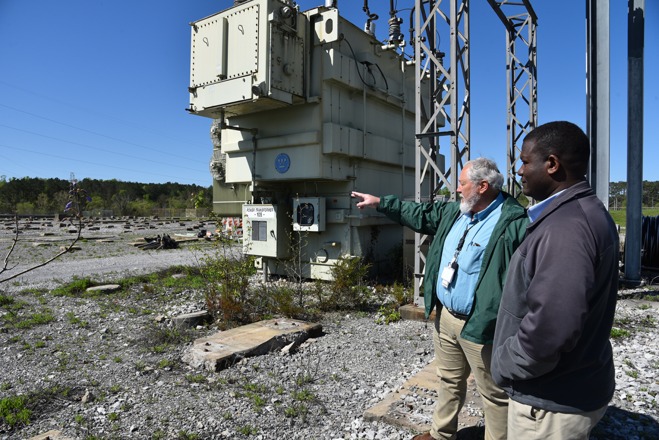 Perry Spurling, UCOR power integration manager, left, discusses the recent transfer of electrical equipment from EM to the City of Oak Ridge with Ardo Ba, electric director for the City of Oak Ridge.