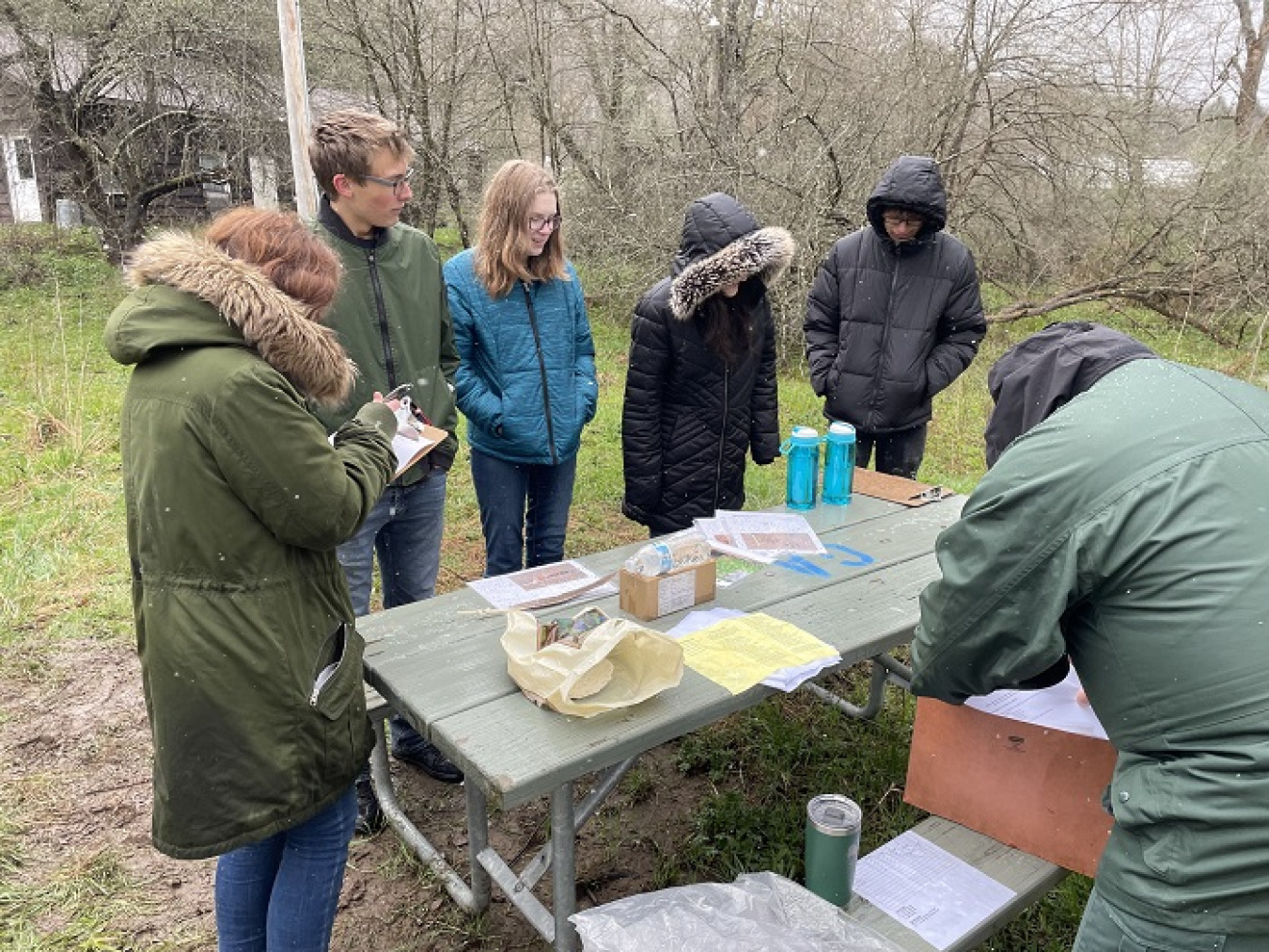 Team members from Olean High School gather around the aquatics station as they compete in the recent Cattaraugus County Envirothon.