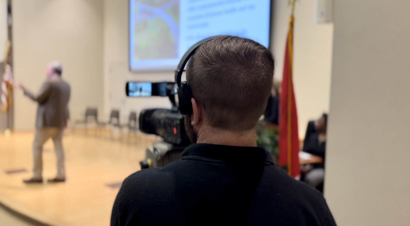 A cameraperson films Roger Petrie, with Oak Ridge Office of Environmental Management (OREM) regulatory affairs, as he gives a presentation about the proposed Environmental Management Disposal Facility at a May 17 public meeting. 