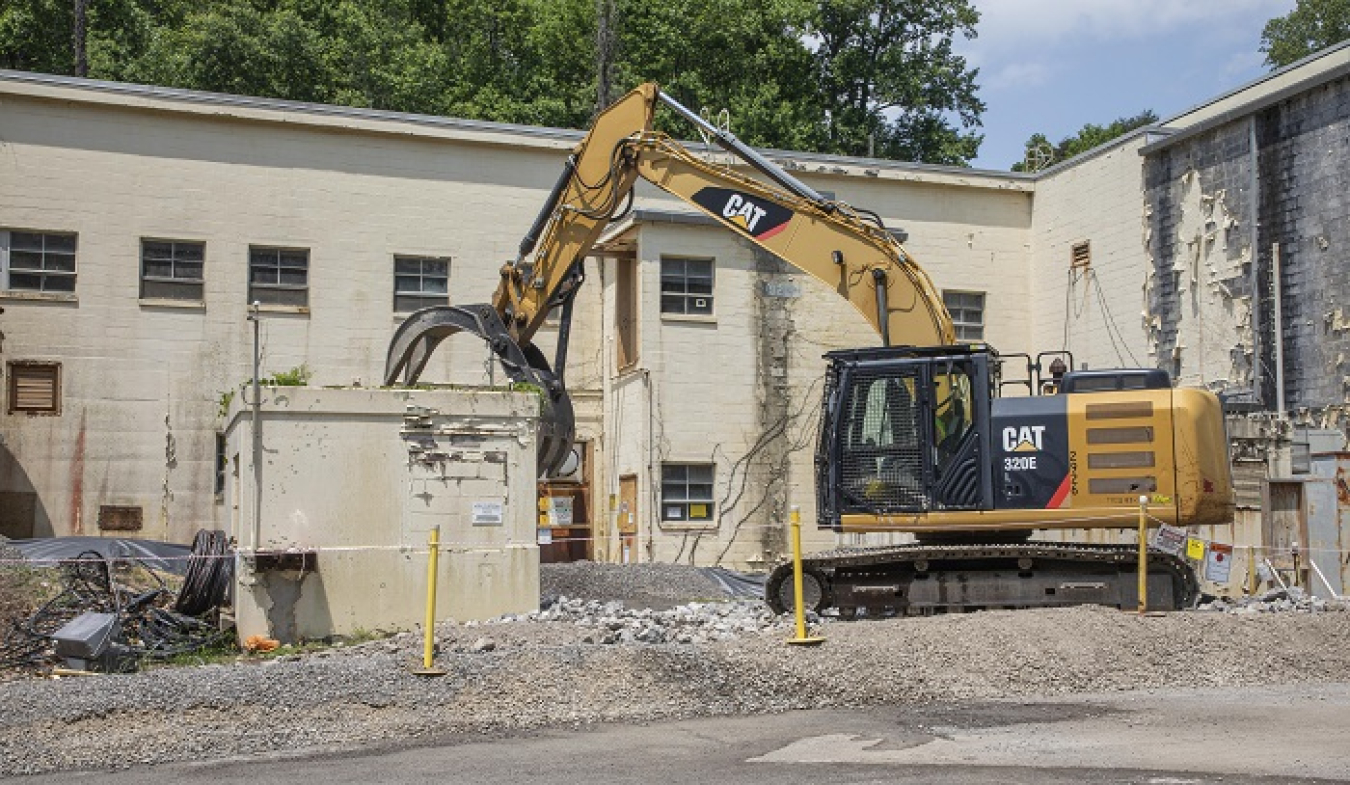 Crews began demolishing the Criticality Experiment Laboratory on the Oak Ridge Reservation by removing some of the auxiliary facilities surrounding the main building.