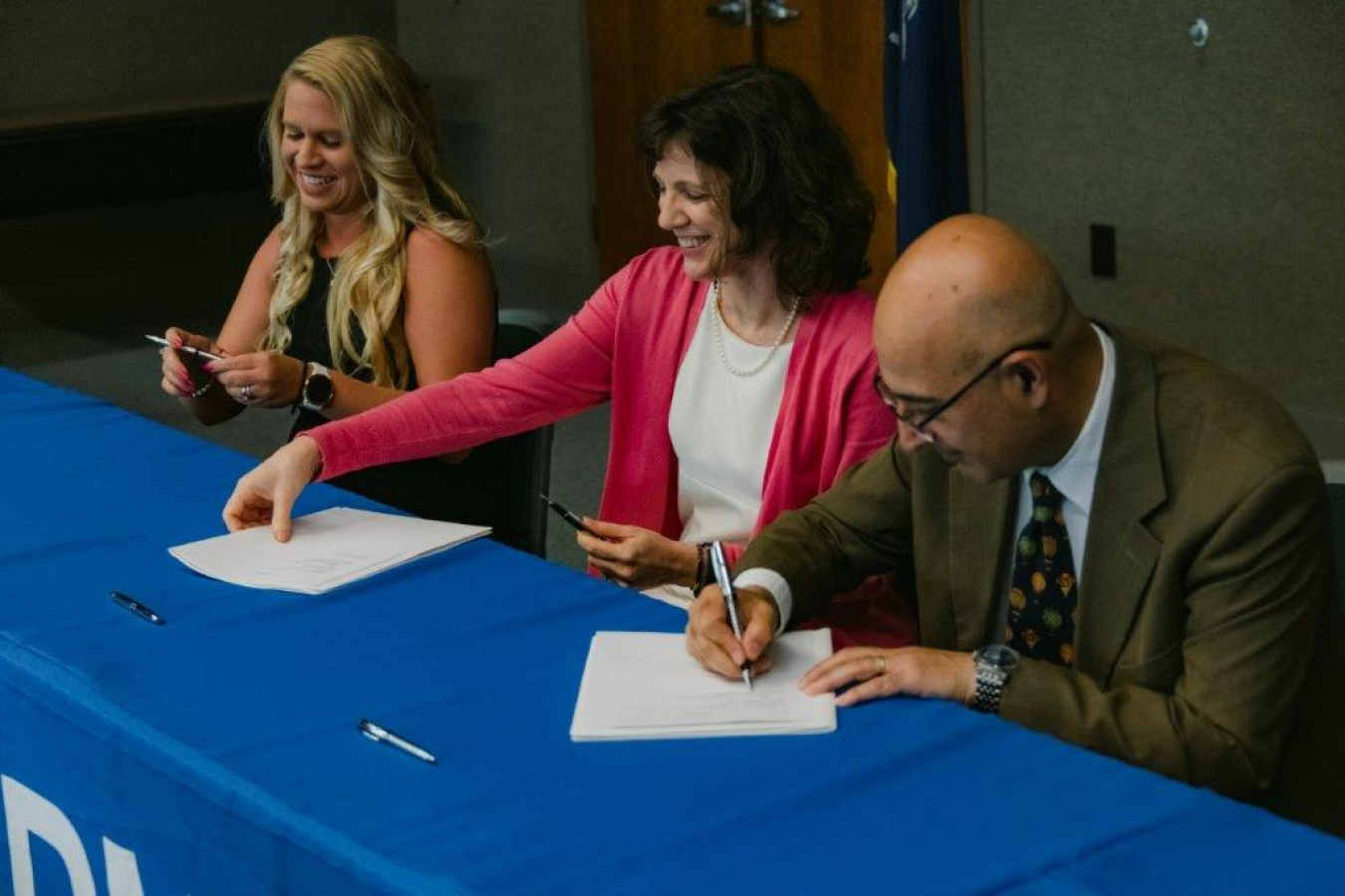 Vahid Majidi, director of the Savannah River National Laboratory (SRNL), right, joins Stephanie Jacobs, director of the Regulatory Center of Excellence, left, and Connie Herman, SRNL director of environmental and legacy management, in signing the Regulatory Center of Excellence charter on May 23.