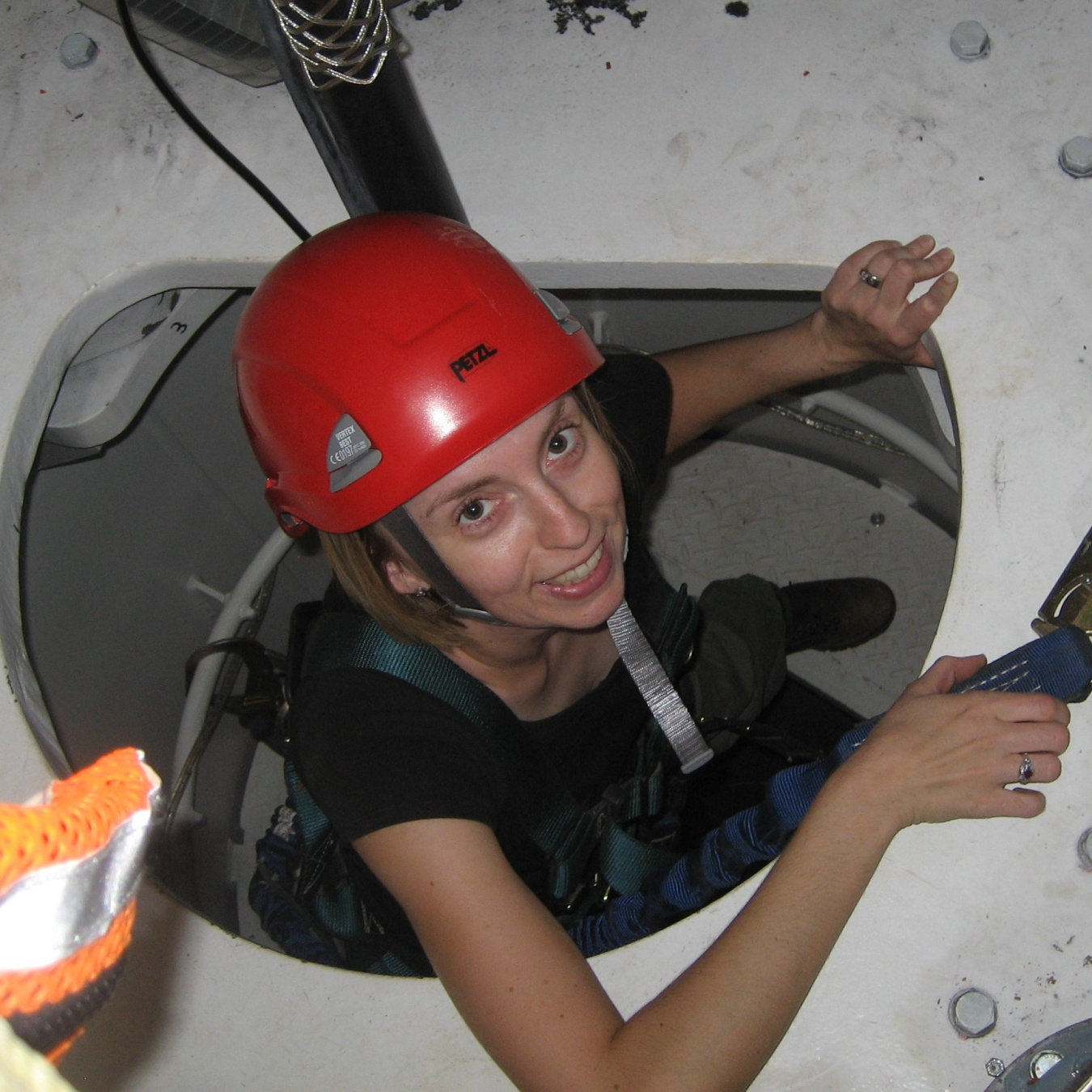 A woman works inside of a wind turbine.